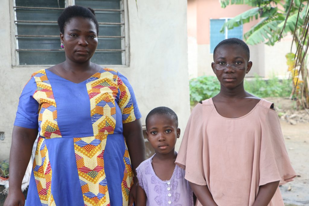 Esther Hodo left beside their mother and Esi Fiatse on the right.