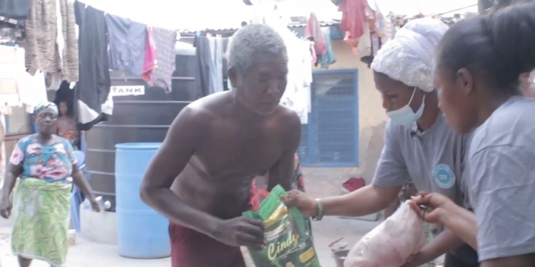 A beneficiary receiving his share of items.